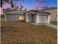 Charming single-story home featuring a one-car garage, neutral stucco, and an arched entryway with manicured lawn at 4601 Copper Ln, Plant City, FL 33566
