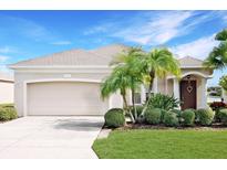 Charming single-story home with a well-maintained lawn, mature landscaping, and a two-car garage at 4174 70Th Street E Cir, Palmetto, FL 34221