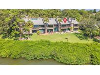 Waterfront condos featuring patios, palm trees, and lush grass for relaxation and tropical living at 1111 N Bayshore Blvd # D6, Clearwater, FL 33759