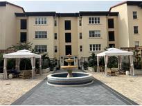 Beautiful courtyard featuring a tiled fountain and lounge areas under white canopies at 200 4Th S Ave # 231, St Petersburg, FL 33701