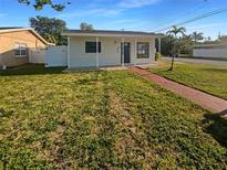 Charming single-story home with a well-maintained lawn and inviting front porch at 701 71St N Ave, St Petersburg, FL 33702