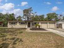 Charming single-story home with a well-maintained front yard, featuring a large driveway and attached two-car garage at 11114 N 21St St, Tampa, FL 33612