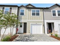 Charming two-story townhome featuring a one-car garage and neutral-toned exterior at 7270 Deer Valley Cir, Tampa, FL 33635