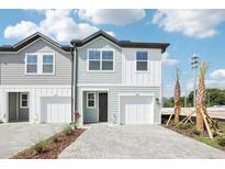 Charming two-story townhome featuring a one car garage and beautifully paved driveway at 7294 Deer Valley Cir, Tampa, FL 33635