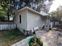Charming single-story home with vinyl siding and a cozy front porch, offering classic curb appeal at 12485 Land St, Largo, FL 33773