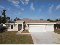 Charming single-story home featuring a three-car garage and well-maintained landscaping at 3105 Lockwood St, Port Charlotte, FL 33952