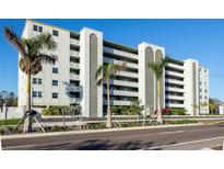 Six-story condo building exterior featuring balconies and palm trees at 7321 Central Ave # 504, St Petersburg, FL 33710