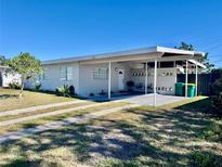 Charming single-story home features a carport, well-maintained lawn, and is located on a sunny lot at 681 Dalton Blvd, Port Charlotte, FL 33952