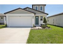 Charming two-story home with a well-manicured lawn and attached two car garage at 3826 Radiant Mountain Dr, Plant City, FL 33565