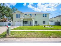 Charming two-story home with a well-manicured lawn and inviting front entrance at 8704 Bay Crest Ln, Tampa, FL 33615