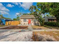 Charming single-story home with a well-maintained lawn, complemented by a bright red front door at 2333 33Rd S St, St Petersburg, FL 33712