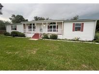 Charming single-story home with a well-maintained lawn and inviting front porch at 4435 Tevalo Dr, Valrico, FL 33596