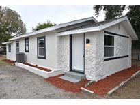 Charming single-story home with stucco and stone accents, updated windows, fresh paint, and newly landscaped at 316 21St W St, Palmetto, FL 34221