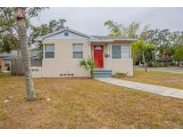 Charming single-story home with a bright red front door and well-maintained lawn at 2001 16Th S St, St Petersburg, FL 33705