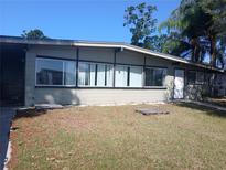 Single story home with large windows and a white front door at 316 Country Club Dr, Oldsmar, FL 34677