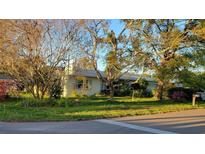 Charming single-story home featuring a well-maintained lawn and mature trees at 6639 Renaldo S Way, St Petersburg, FL 33707