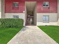 Exterior view of the two-story condo with landscaped walkway leading to the units at 8608 Huron Ct # 57, Tampa, FL 33614