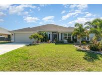 Charming single-story home with a well-manicured lawn and lush tropical landscaping at 2248 Bonn Ct, Punta Gorda, FL 33983