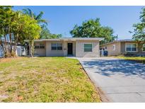 Charming single-story home with a well-maintained lawn and a classic neutral color palette at 4621 25Th S Ave, St Petersburg, FL 33711