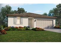Charming single-story home features a well-manicured lawn and a neutral color palette at 1752 Brekey Way, Zephyrhills, FL 33541