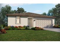 Inviting single-Gathering home featuring a two-car garage, neutral color palette, and neatly landscaped front yard at 228 Lazy Shore Dr, Nokomis, FL 34275