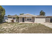Charming single-story home featuring a covered entrance and brick walkway to the front door at 3206 Peterborough St, Holiday, FL 34690