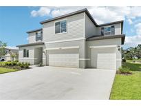 Beautiful two-story home with a two-car garage, lush lawn, and well-maintained landscaping at 14035 Kelly Park Ct, Parrish, FL 34219