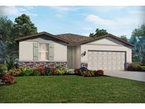 Charming single-story home featuring stone accents, a two-car garage, and lush landscaping at 7736 Gilchrist Springs Dr, Parrish, FL 34219