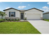 Charming single-story home with a well-manicured lawn and inviting front entrance at 7736 Gilchrist Springs Dr, Parrish, FL 34219