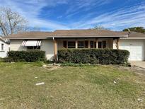 Modest single story home with a covered entry, one-car garage, and mature landscaping at 4800 Fleetwood St, New Port Richey, FL 34653