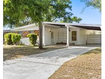 Charming single-story home featuring a brick accent, covered carport, and well-maintained front yard at 1820 Marvy Ave, Tampa, FL 33612