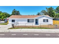 Charming white home featuring black window trim, a freshly painted exterior, and a well-manicured lawn at 7824 Starkey Rd, Seminole, FL 33777