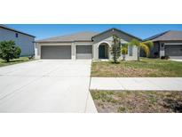 Charming single-story home with a three-car garage and well-manicured front yard at 11910 Field Thistle Ct, Riverview, FL 33579