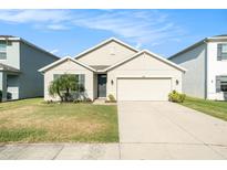 Charming single-story home with a well-manicured lawn and attached two-car garage in a quiet neighborhood at 2587 Garden Plum Pl, Odessa, FL 33556