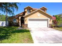 Charming two-story home with well-maintained lawn and attached two car garage at 31141 Harthorn Ct, Wesley Chapel, FL 33543