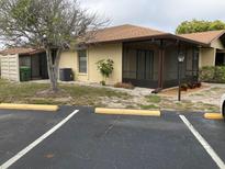 Cozy single-story home featuring a screened-in porch, complemented by an asphalt driveway and neat landscaping at 4152 66Th Street W Cir # 4152, Bradenton, FL 34209