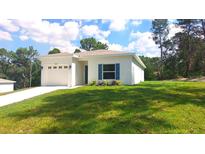 Charming single-story home with a well-manicured lawn and attached two-car garage at 8990 Glenarm Way, Weeki Wachee, FL 34613