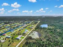 Stunning aerial view of a waterfront community with canals and lush landscaping under a sunny sky at 235 Rotonda S Blvd, Rotonda West, FL 33947