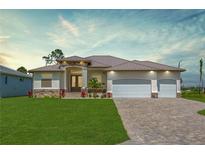 Beautiful single-story home featuring manicured lawn, stone accents, three-car garage, and a brick-paved driveway at 235 Rotonda S Blvd, Rotonda West, FL 33947