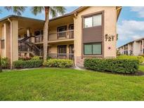 Inviting condo building with manicured lawn and lush landscaping in a well-maintained community at 721 83Rd N Ave # 108, St Petersburg, FL 33702