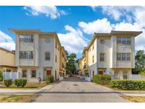 Charming townhouses featuring a cream and yellow exterior with manicured landscaping and an inviting street view at 4409 W Gray St # 5, Tampa, FL 33609