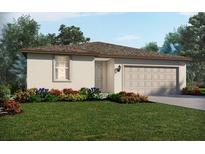 Charming single-story home with a well-manicured lawn and a two-car garage at 7740 Gilchrist Springs Dr, Parrish, FL 34219