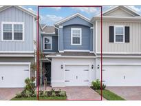 Charming two-story townhome featuring an attached garage, brick paved driveway, and manicured landscaping at 42858 Park View Dr, Punta Gorda, FL 33982
