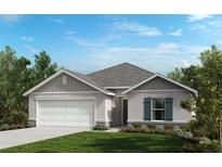 Charming single-story home featuring a two-car garage and beautifully manicured lawn and lovely green shutters at 20183 Azul Marble Loop, Land O Lakes, FL 34638