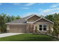 Charming single-story home featuring stone accents, a two-car garage, and professionally landscaped yard at 6359 Burning Opal Bnd, Land O Lakes, FL 34638