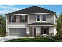 Charming two-story home featuring a gray exterior, well-manicured lawn, and a two-car garage at 9414 Sandy Bluffs Cir, Parrish, FL 34219