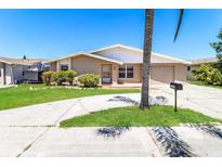 Charming single-story home featuring a well-maintained lawn, driveway, and attached garage at 7221 King Arthur Dr, Port Richey, FL 34668