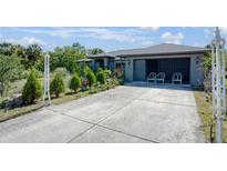 Charming single-story home with well-maintained landscaping, a spacious driveway, and attached two-car garage at 268 Cory St, Port Charlotte, FL 33953