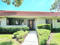 Charming villa featuring a red-tiled roof, well-maintained landscaping, and a welcoming entrance at 2055 Lakeview Dr, Clearwater, FL 33763