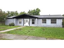 Charming single story home with a stone accent wall and well-maintained lawn at 2202 Whitney Pl, Valrico, FL 33594